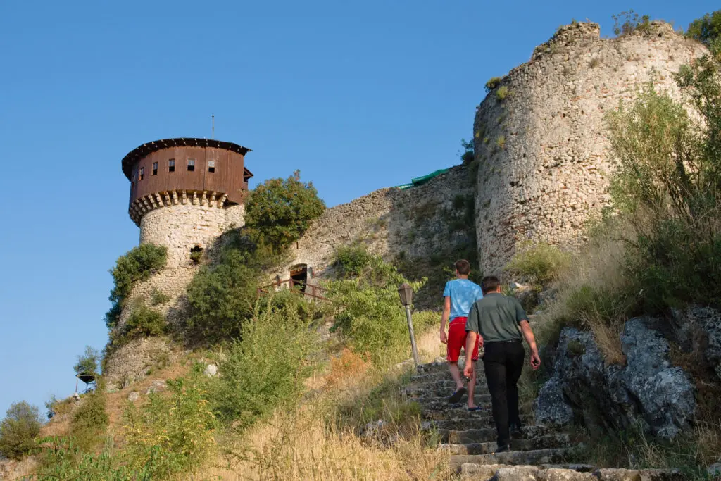 Two visitors go up the stairs that lead to the castle Petrele; the Petrele castle, in ancient times was known as Petralba, is one of the tourist locations close to Tirana and it has two observation towers