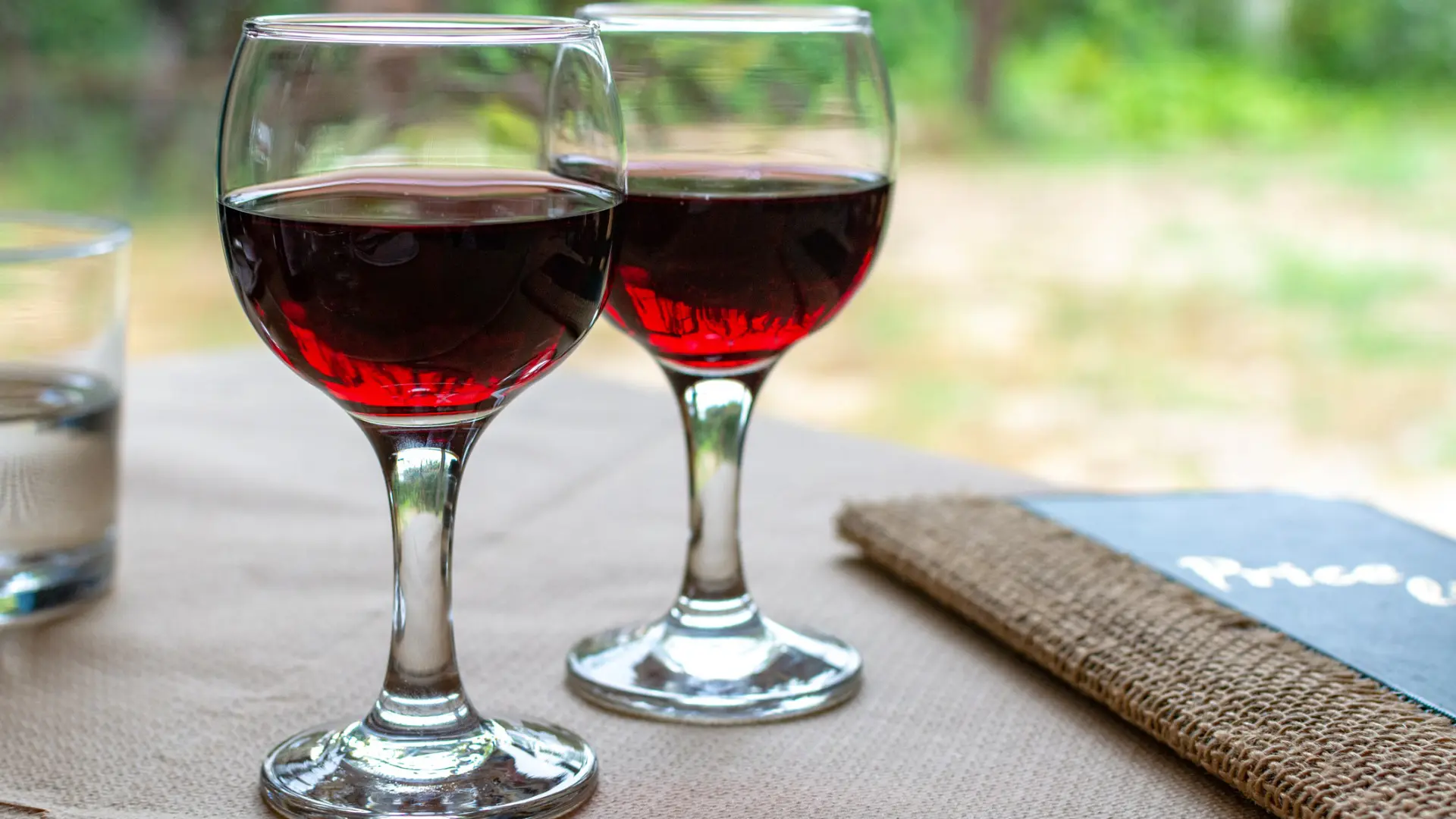 This is a close up of two glasses filled with red Agiorgitiko wine. Agiorgitiko is one of the best Greek wines.