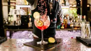 This image shows a bartender preparing a fancy-looking cocktail. It's the featured image of our Best Cocktail Bars in Istanbul article.