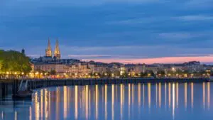 This is a panoramic view of Bordeaux, France, at dusk.