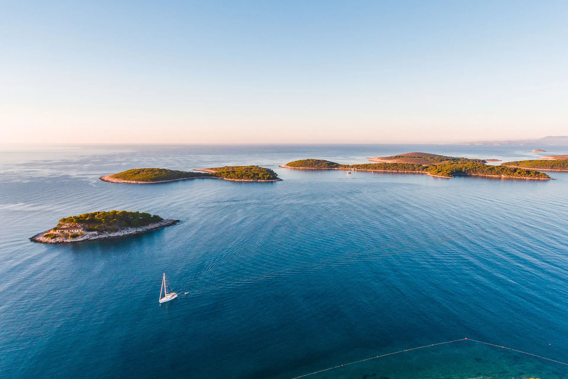This is a drone shot of tiny islands dotting the sea.