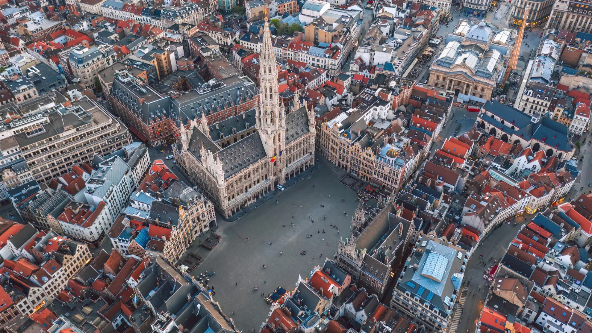 This is an aerial view of Brussels. In the center of the image, the Grand Place is dominated by the city's Town Hall.