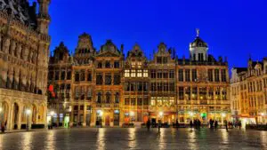 This image shows the magnificent guild houses of Grand Place at dusk.