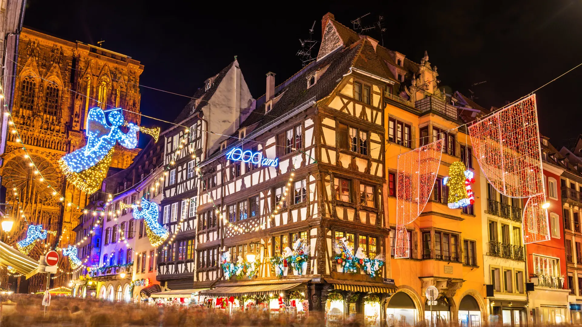 This night shot shows several beautiful buildings in Strasbourg with Christmas lights and decorations.