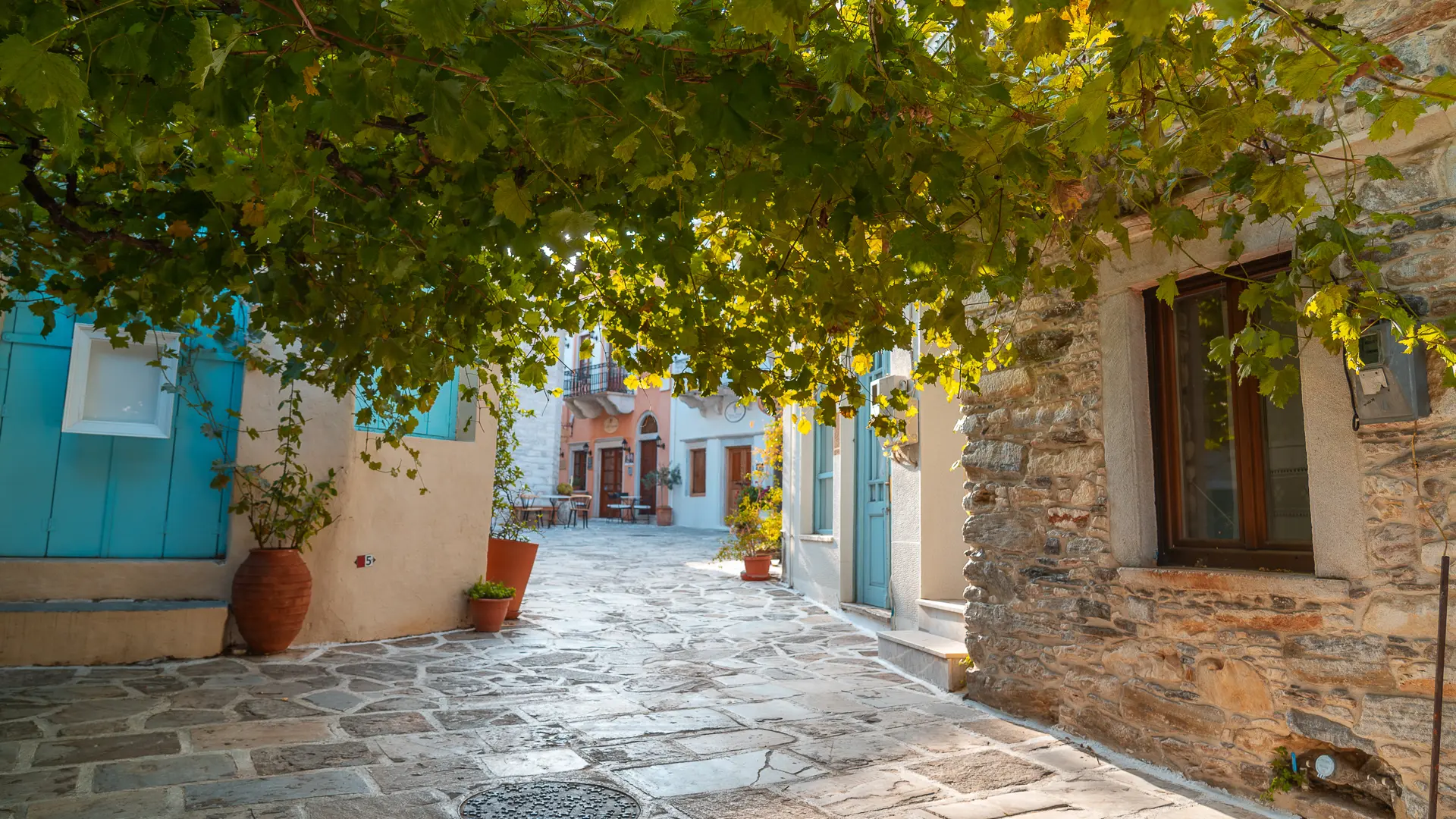 A quaint alley with stone houses in Chalki. If you're wondering which Greek Islands should I visit for a family vacation, Naxos is the one!