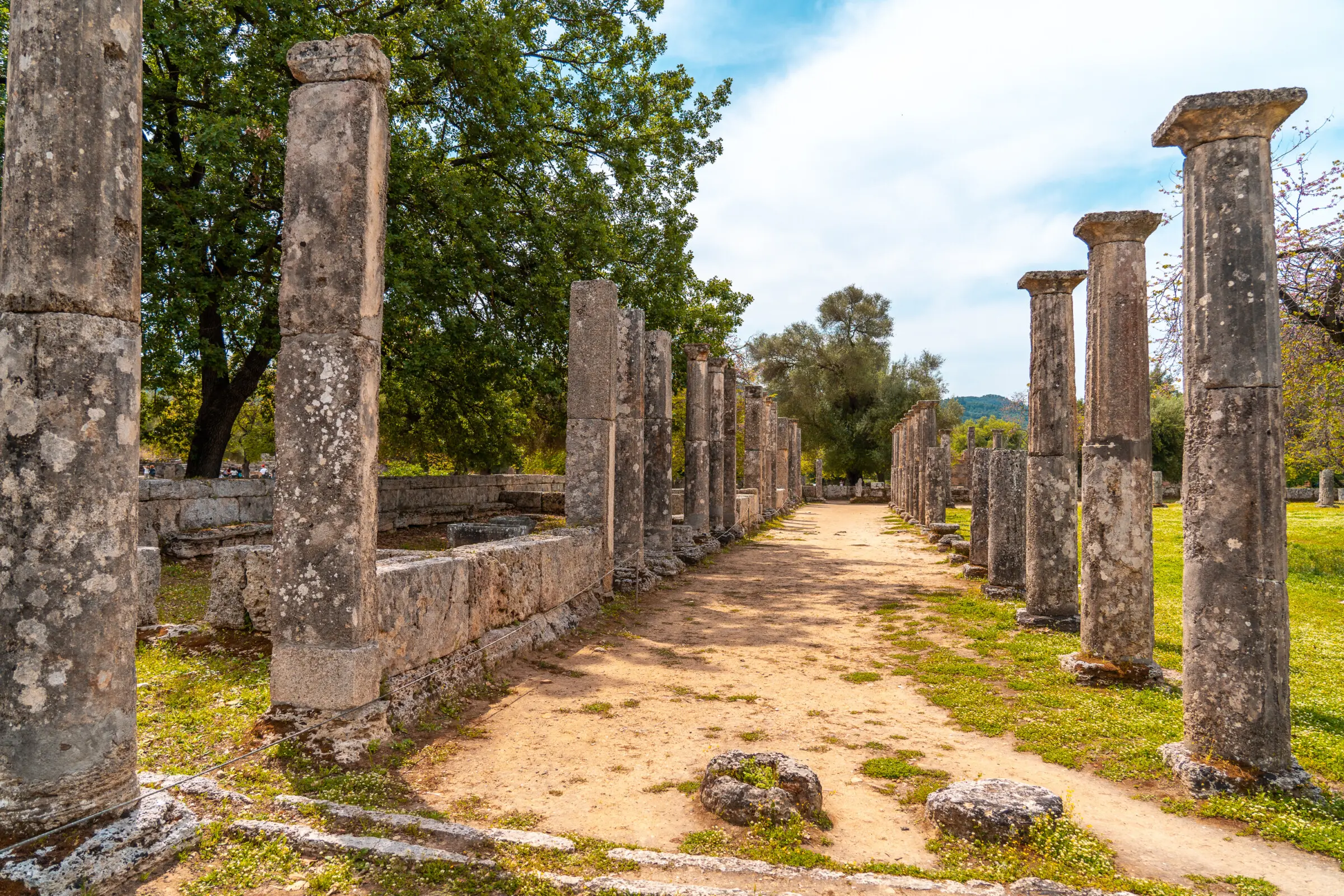 This image shows two sets of columns amidst trees.