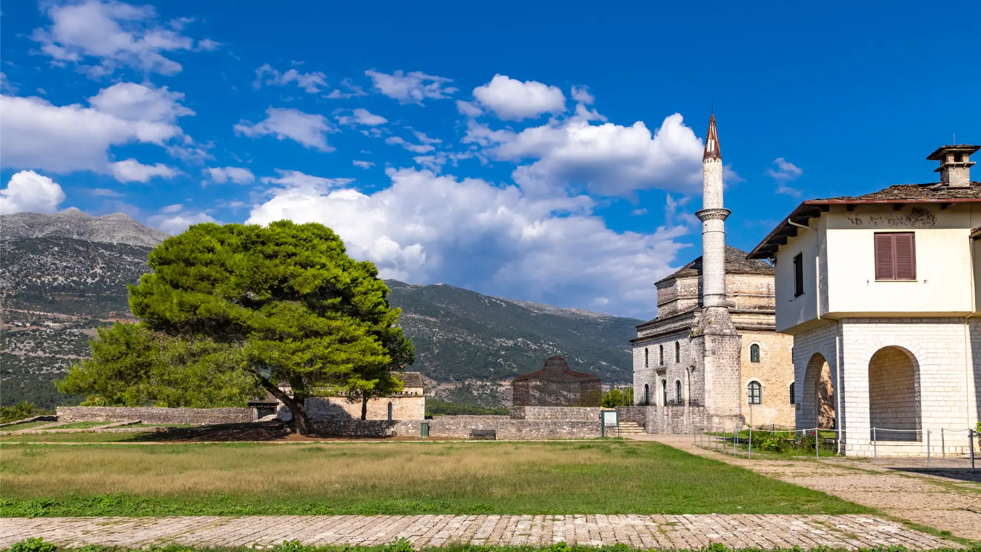 This image shows a mosque and a traditional Epirus building, both within the grounds of the Castle of Ioannina.