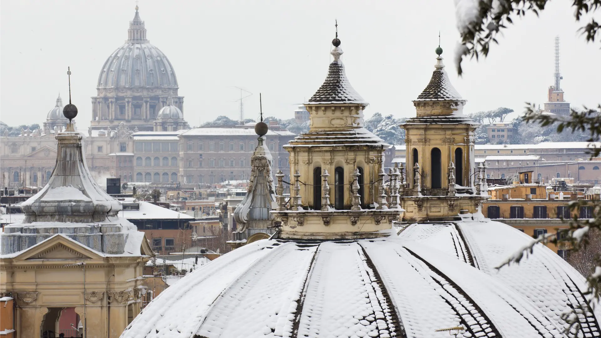 This is a close up of Rome's skyline with snow on the rooftops.