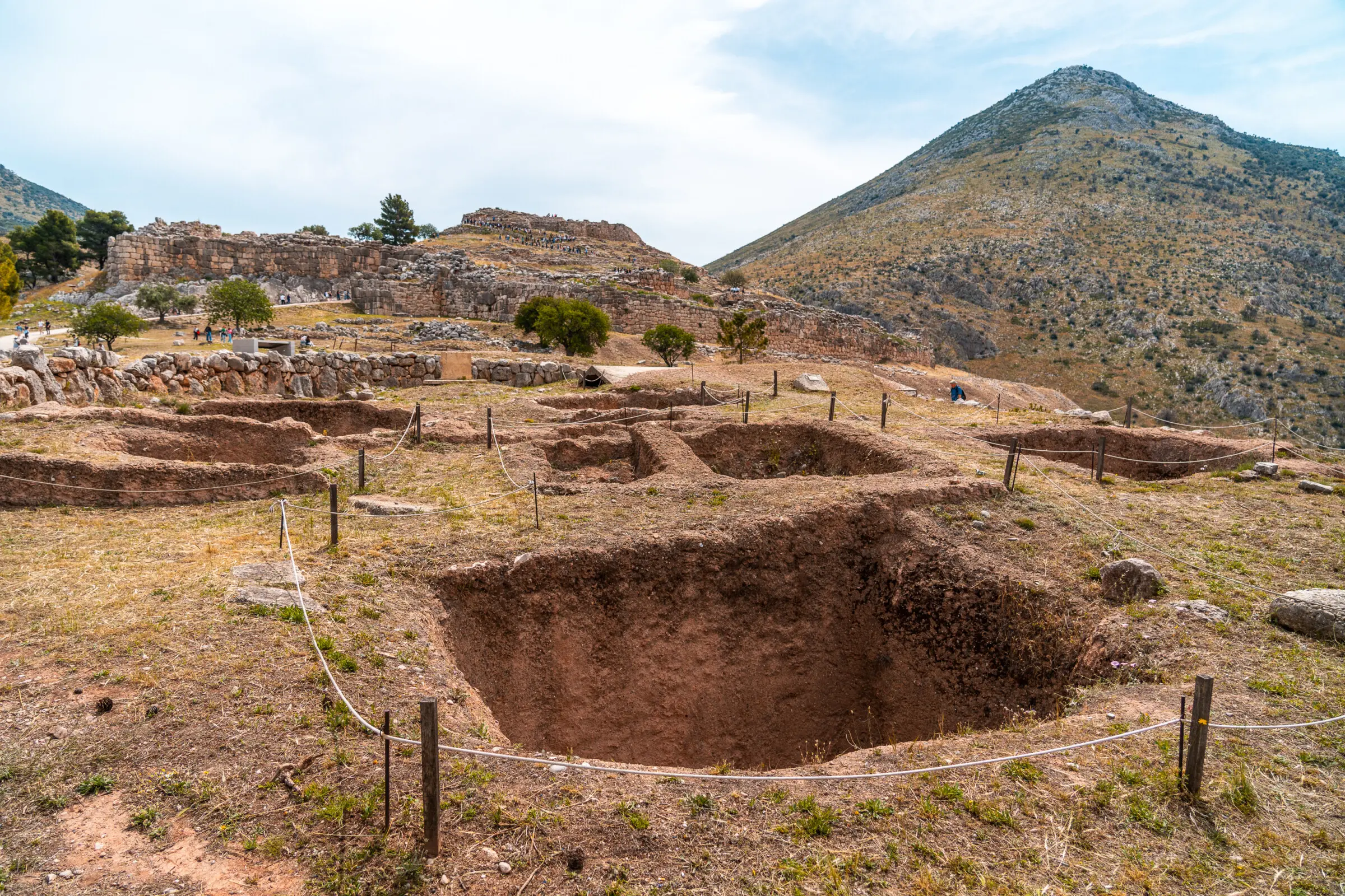 This image shows ancient tombs. They're large holes on the ground.