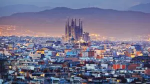This image shows the skyline of Barcelona dominated by La Sagrada Familia in the blue hour.