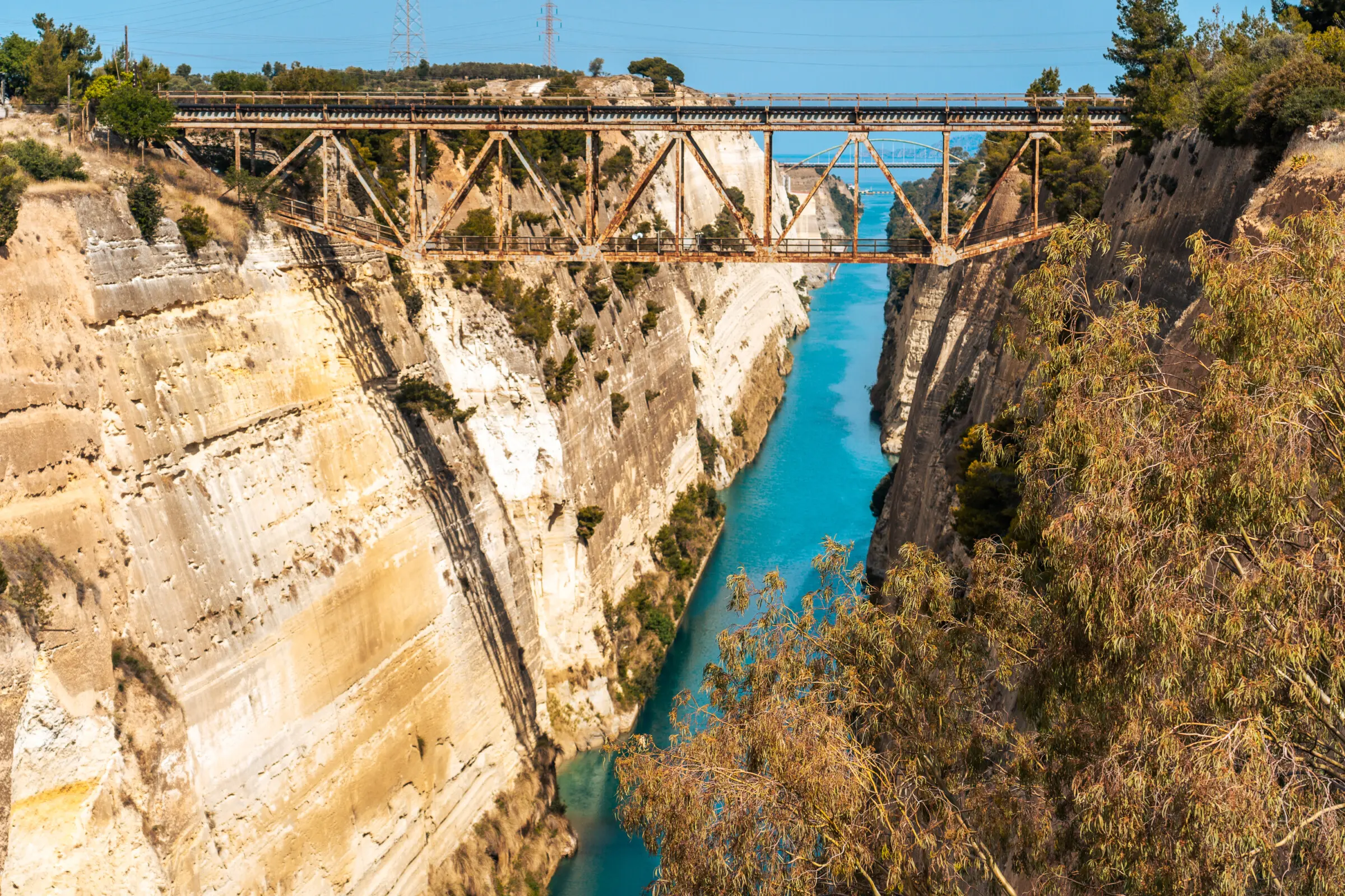 This image shows the Corinth Canal with the old - now disused - railway bridge above it.