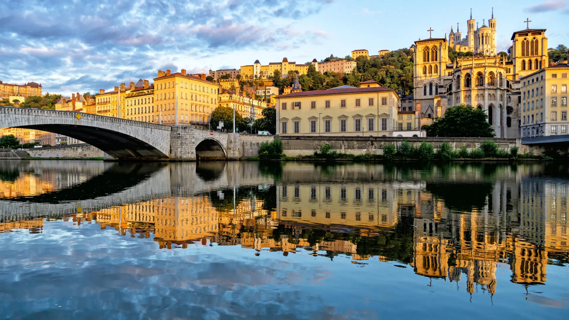 This image shows beautiful buildings and their reflections on a calm river.