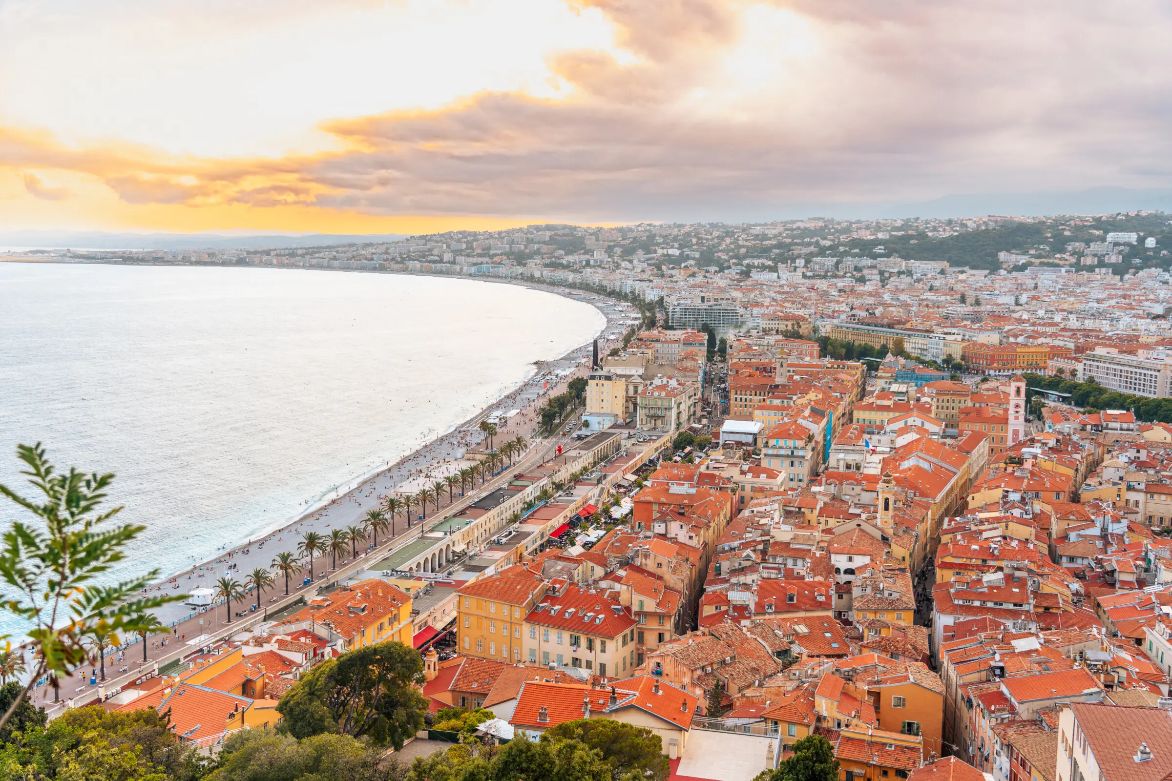 This is an aerial shot of Nice with its red rooftops and long beach.