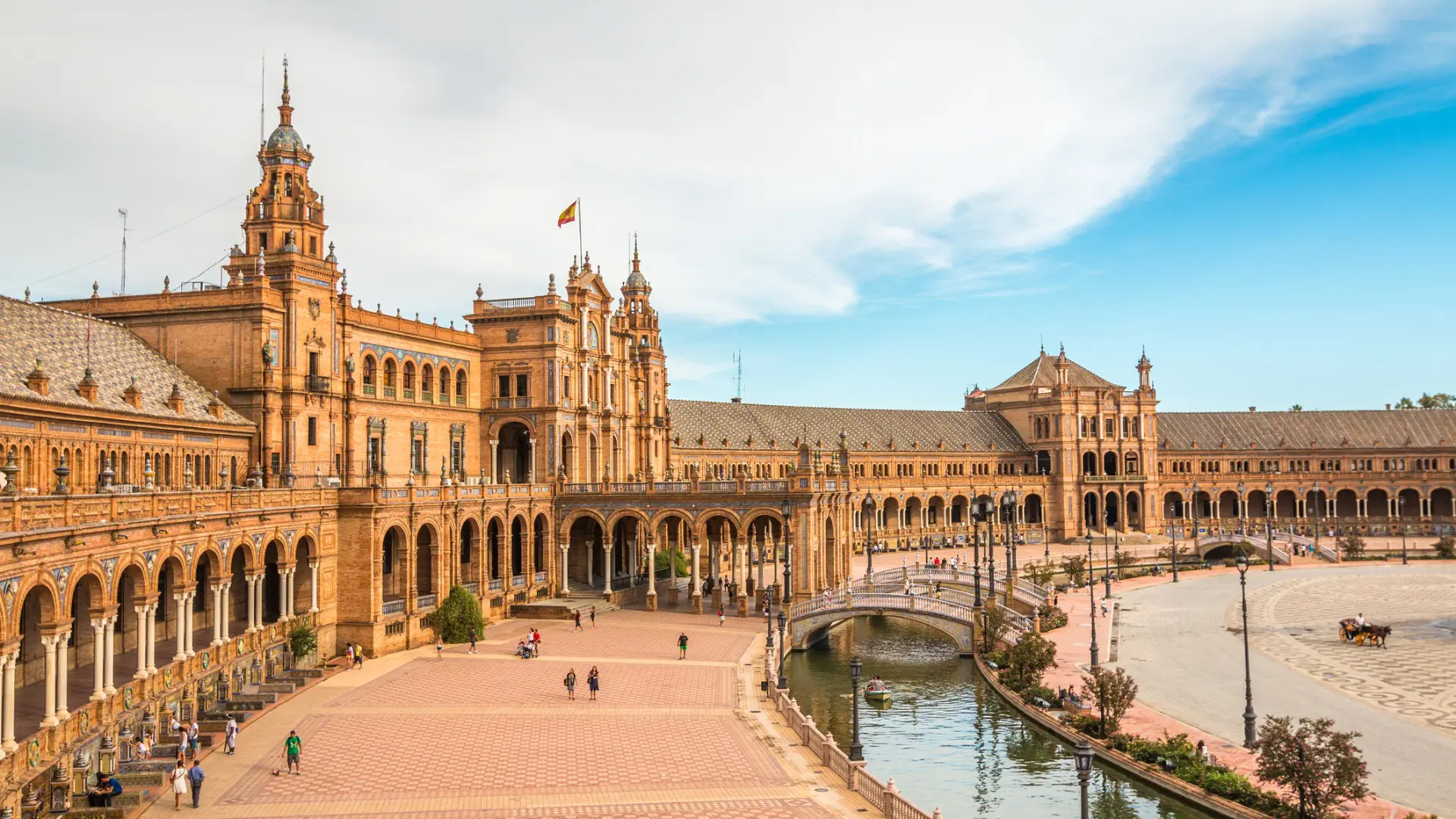 The buildings and canal of Plaza de Espana in Seville, one of the best places to visit in Spain.