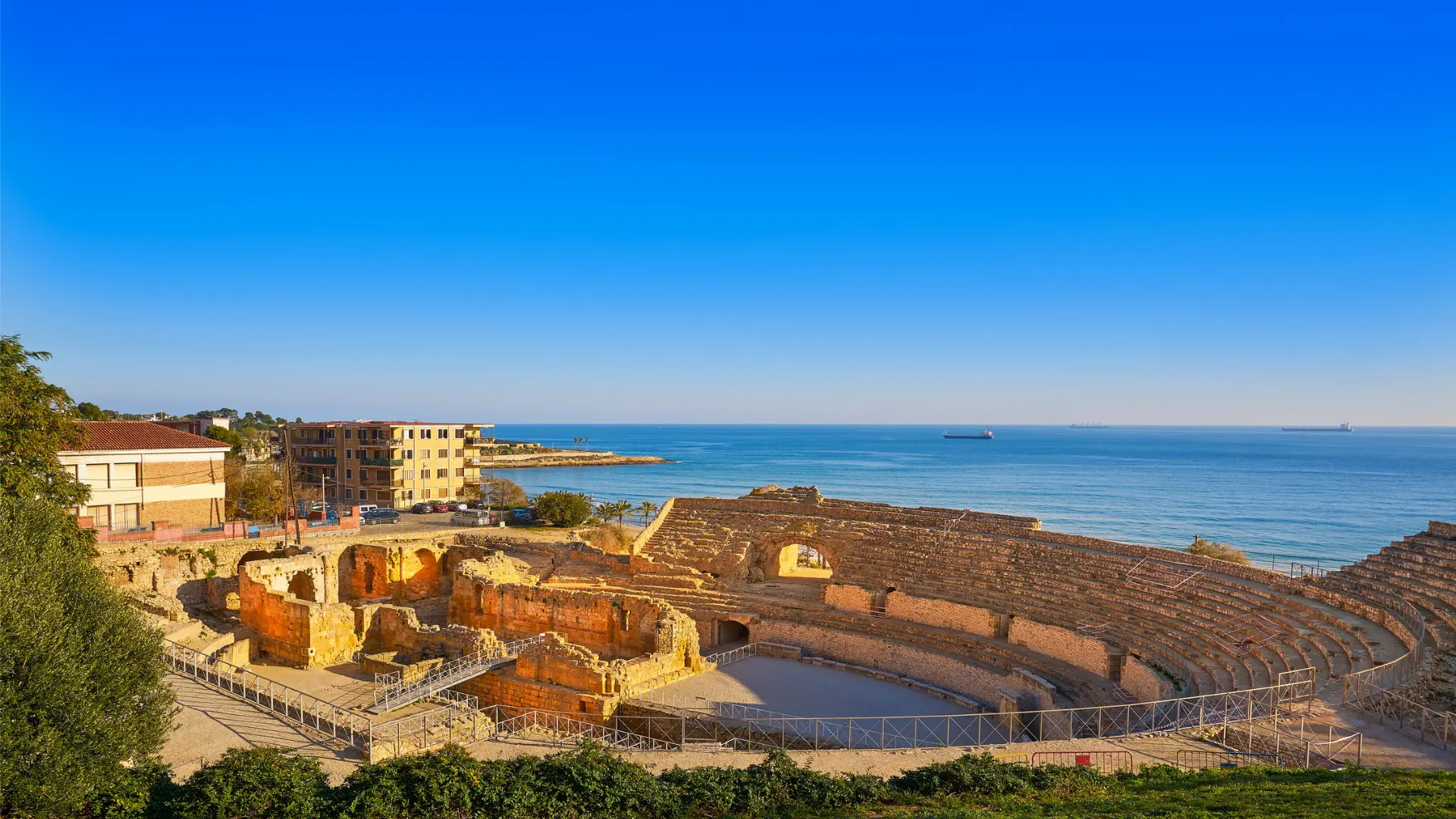 This image shows Tarragona's Roman amphitheater with the sea in the background.