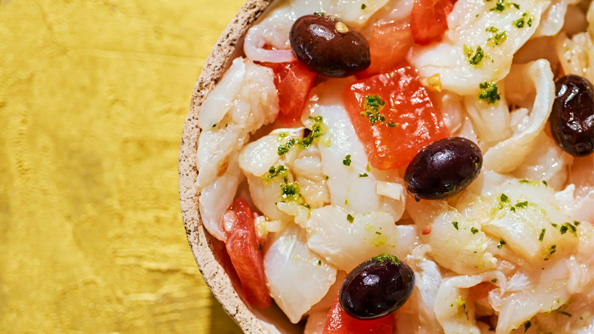 This is a close-up of Esqueixada, cod, tomatoes, and black olives.