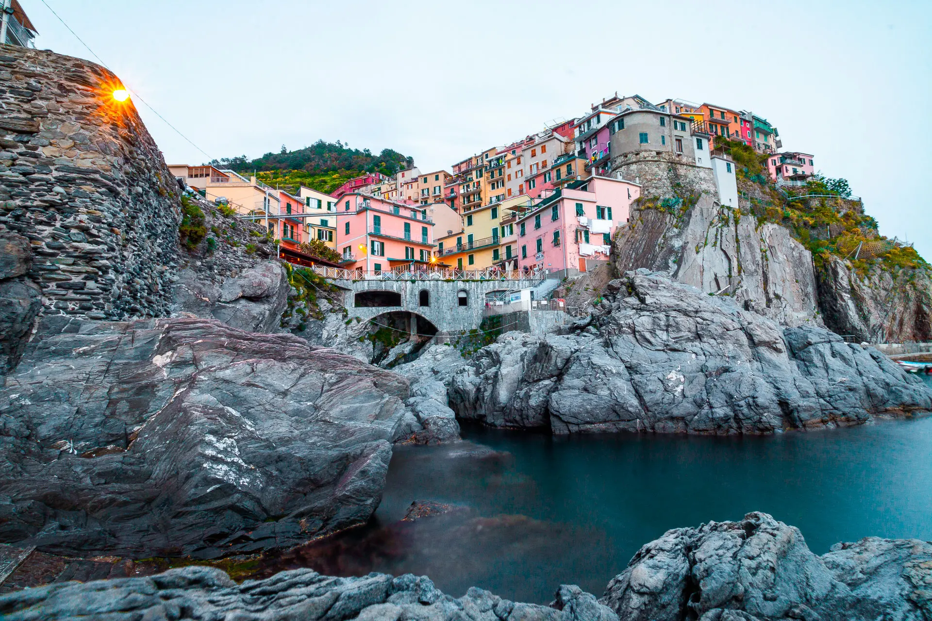 This image shows a colorful village built atop dramatic grey cliffs.