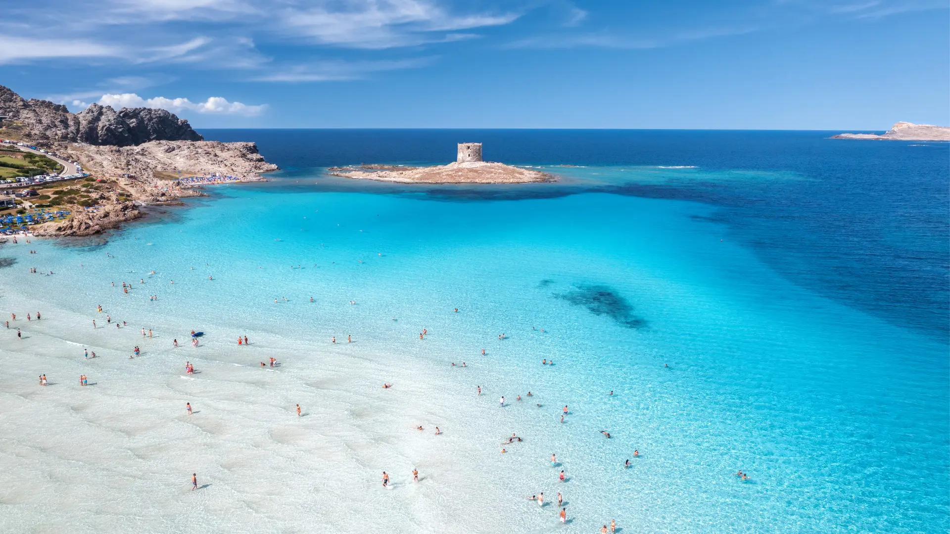 This is a panoramic shot of the transparent waters of La Pelosa Beach in Sardinia.