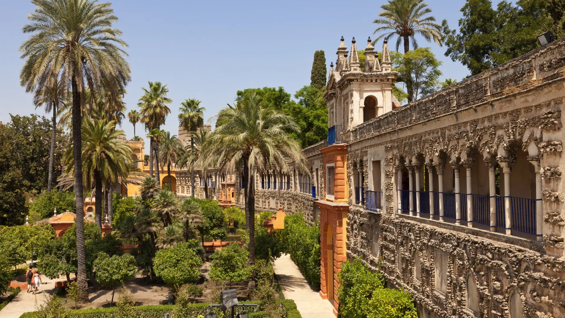 This is a panoramic view of the gardens of the Royal Alcazar in Seville, Spain.
