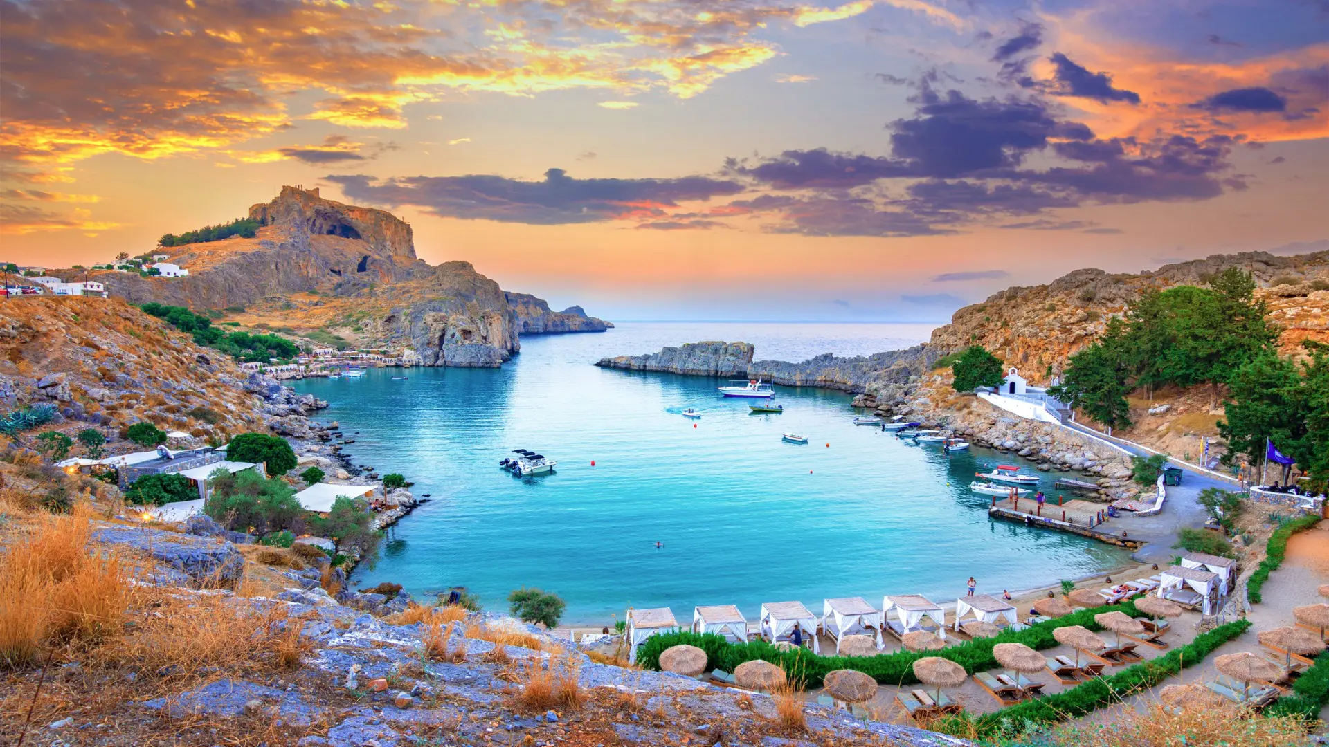 A panoramic view of Saint Paul's Bay in Lindos Rhodes at sunset.