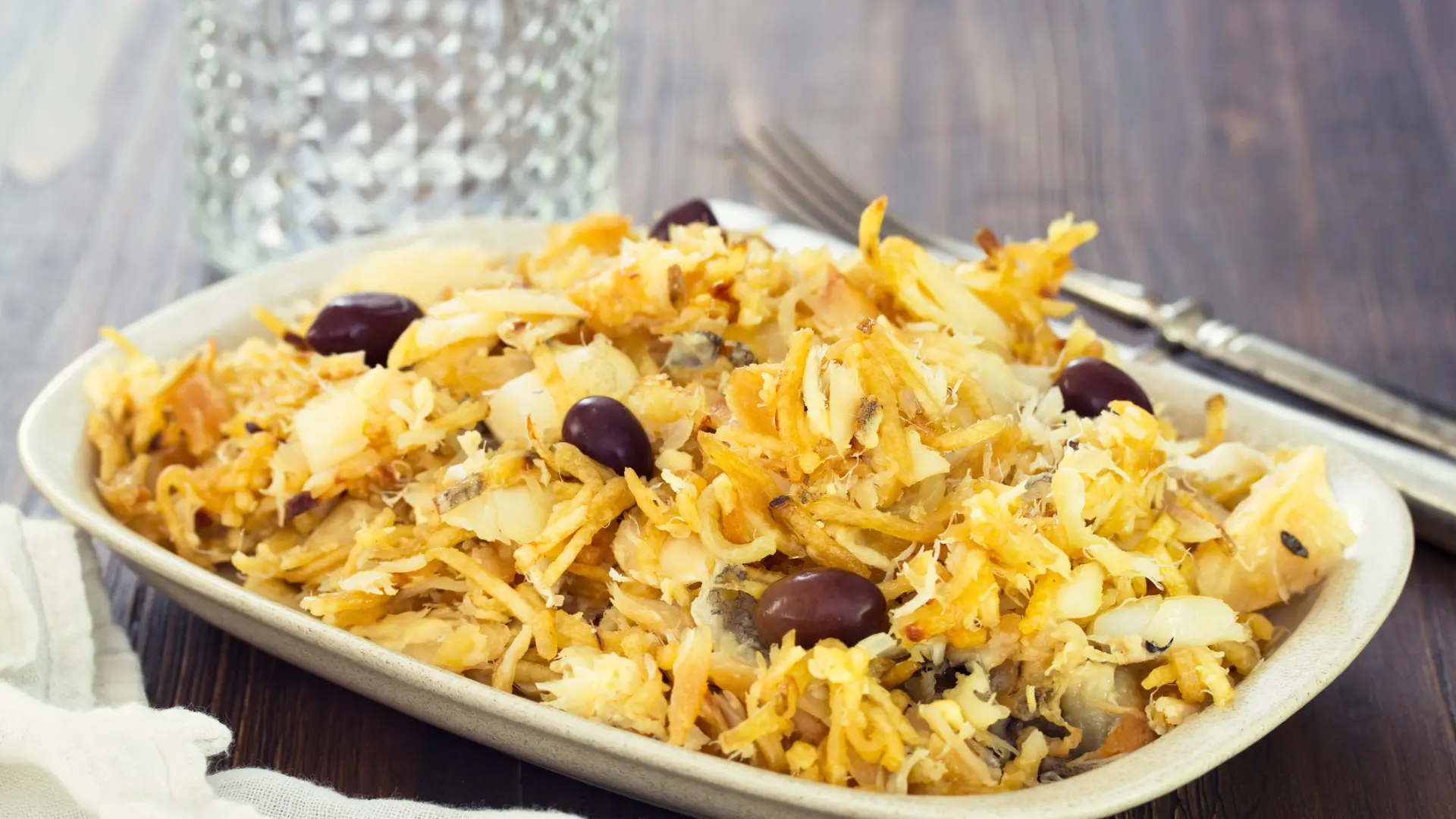 A close-up of a dish of Bacalhau a Bras, a staple of the best Portuguese food.