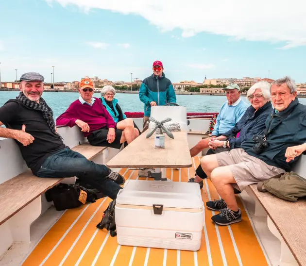 A group of travelers on a boat trip in Sicily.
