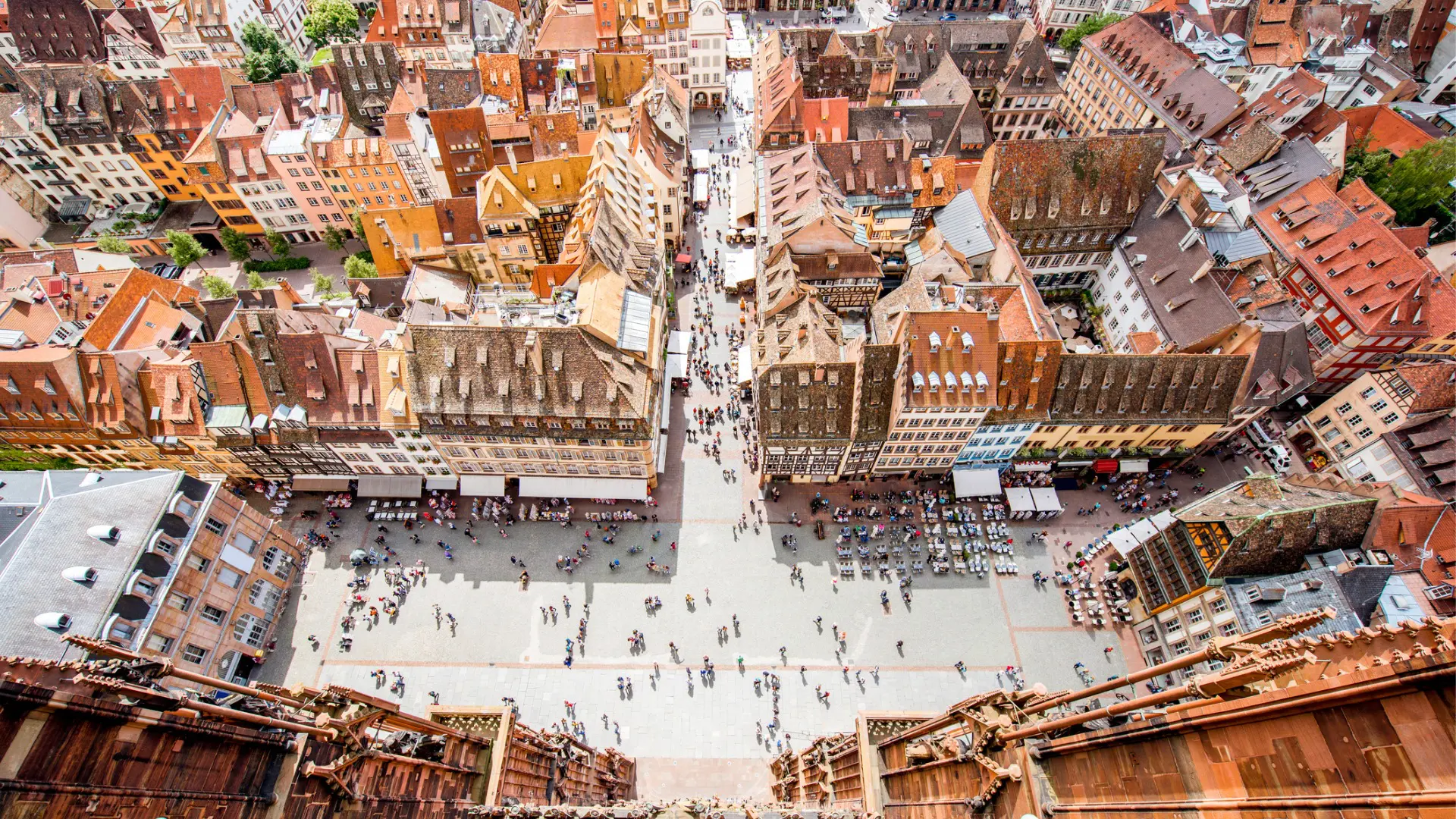 A panoramic view of Strasbourg's red-tiled rooftops from above.