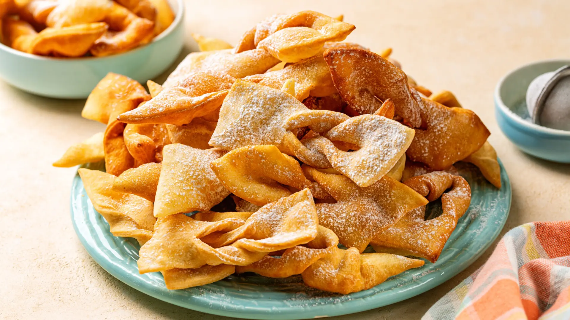 A light blue plate filled with Faworki treats.