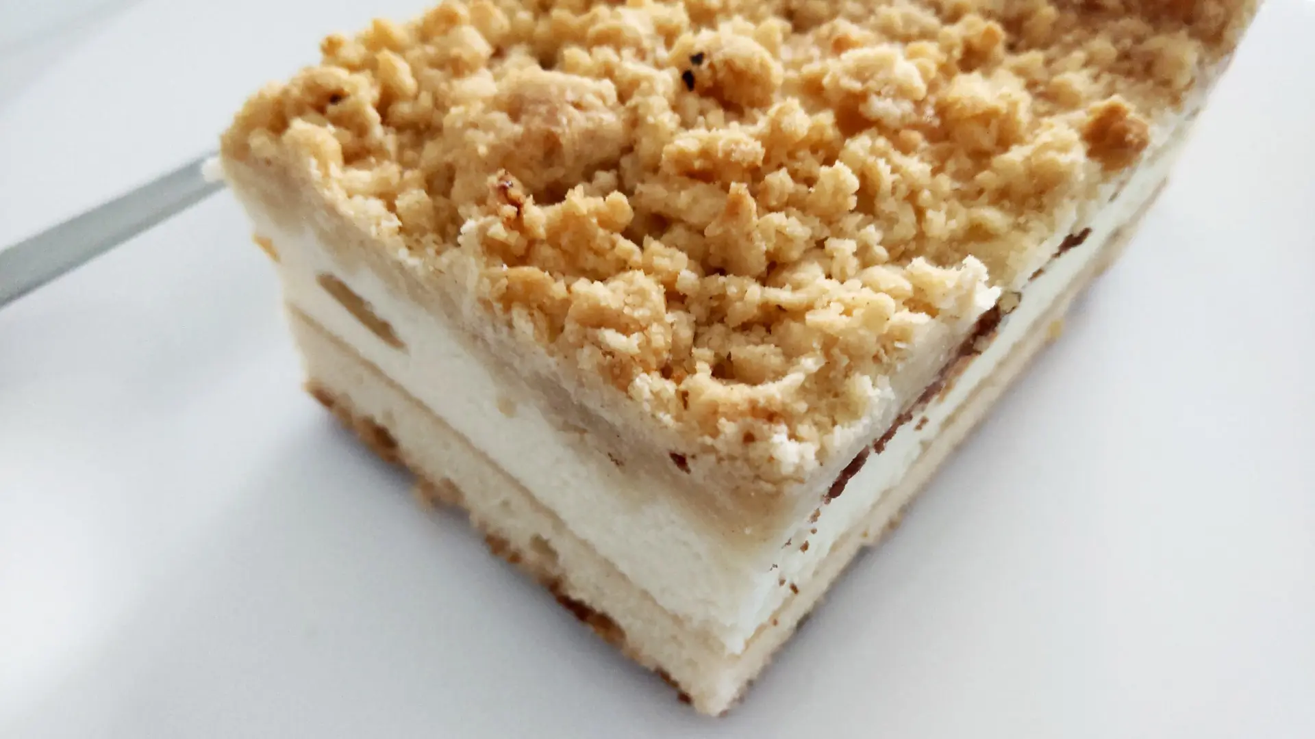 A close up of a layered crumb cake.