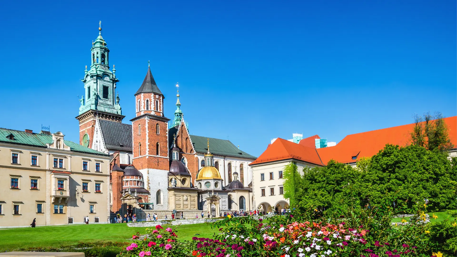 Krakow's Wawel Castle and Cathedral Square with flowers in the foreground.