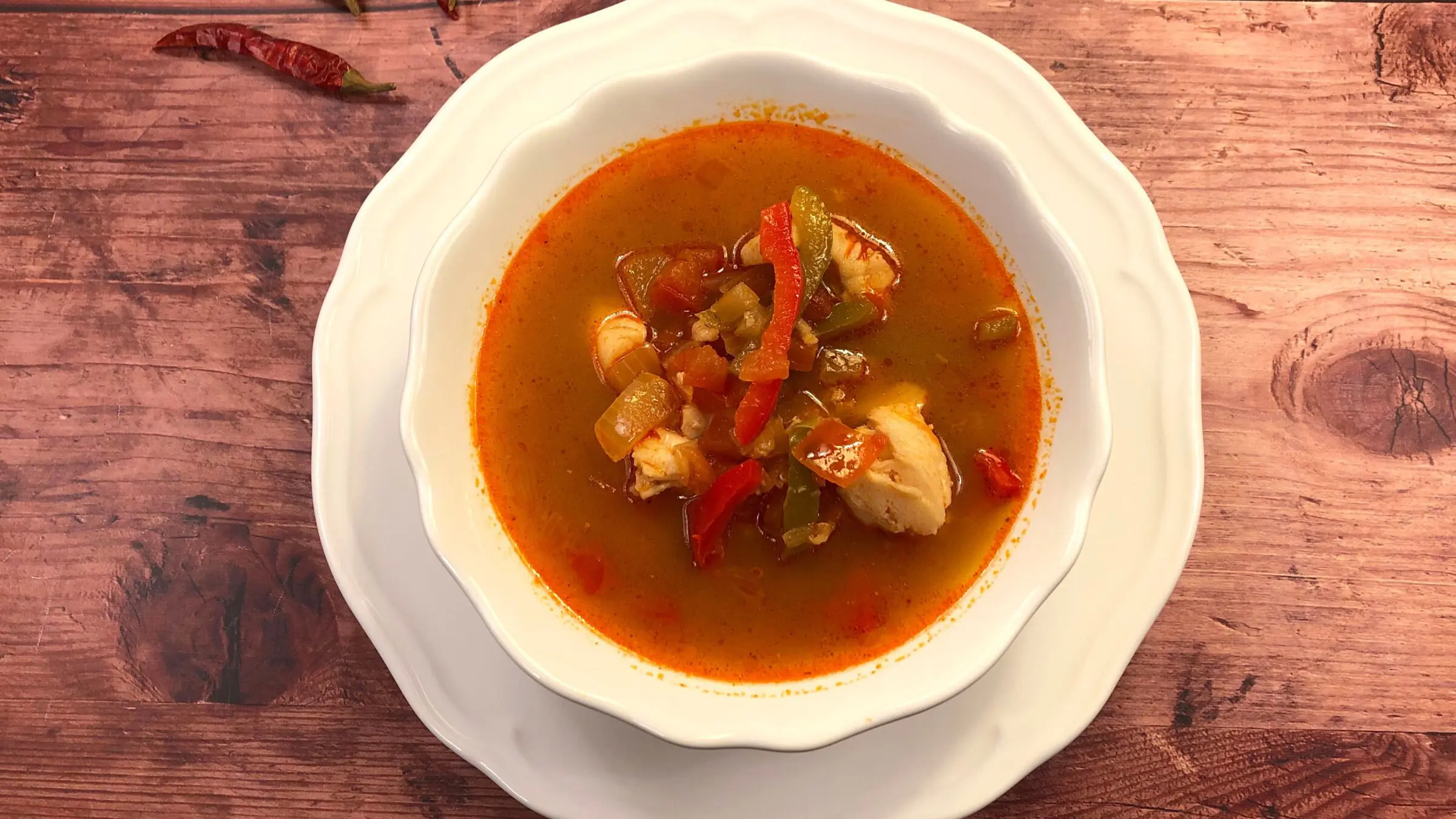 A top-down photo of a fish soup in tomato sauce, the best Hungarian food that's not meat-based.