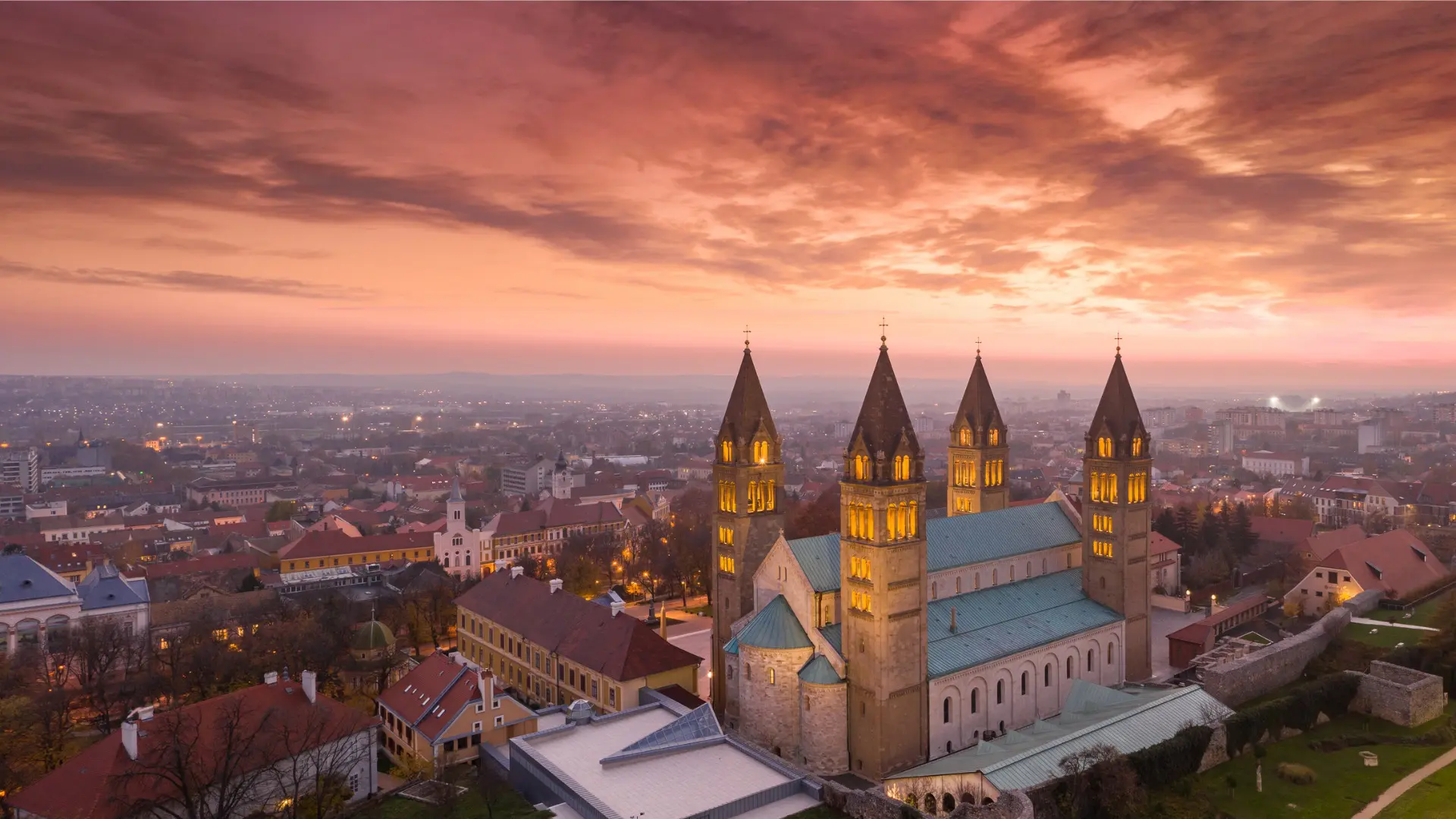 The illuminated Cathedral of Pecs under a gorgeous sunset sky.