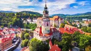 An aerial view over the historic center of Cesky Krumlov and the Vltava River.