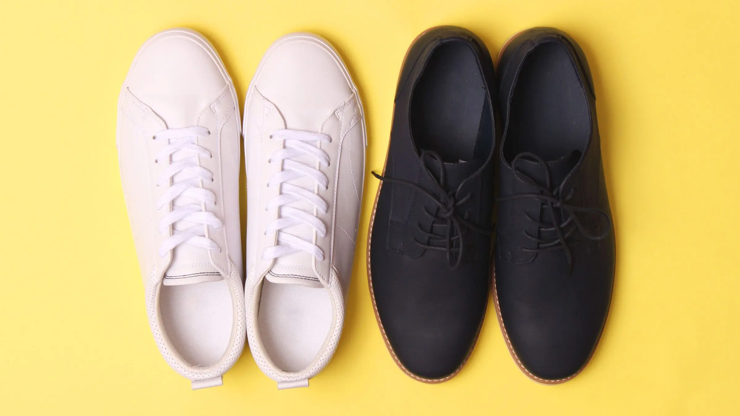 Men's office shoes and sneakers on a yellow background.