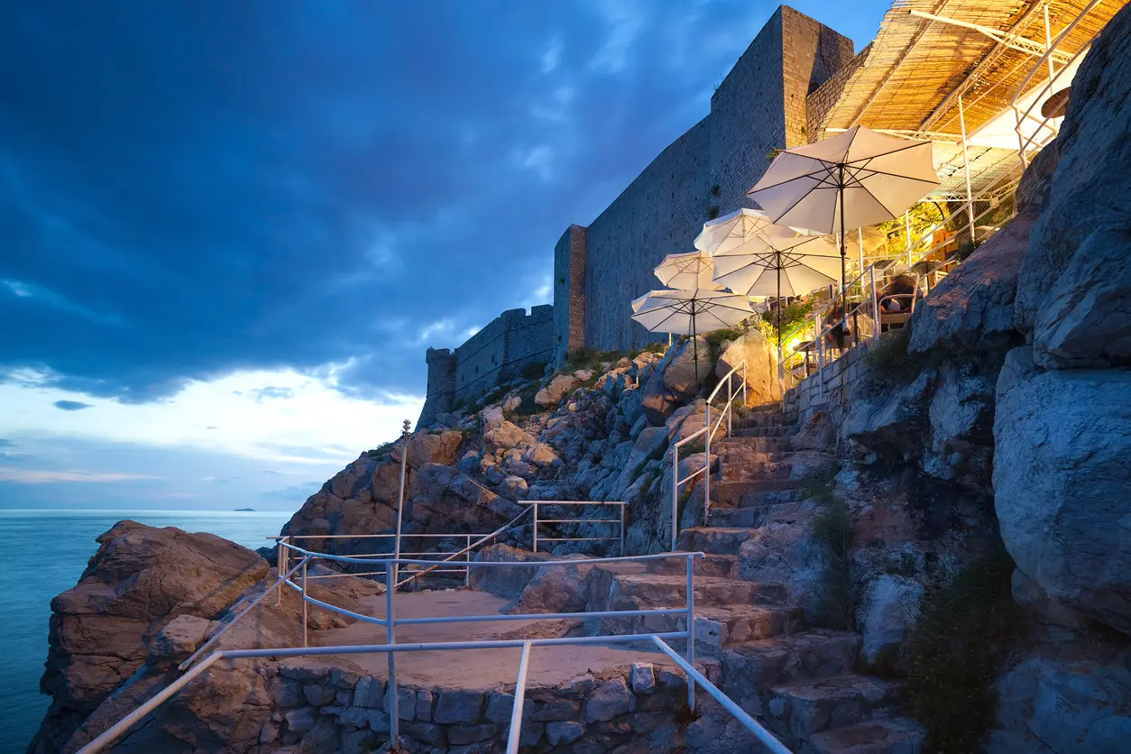 Buza beach café at night. It is one of the most beautiful bars in Dubrovnik, built on the cliffs right above the sea, with an amazing view of the Adriatic.