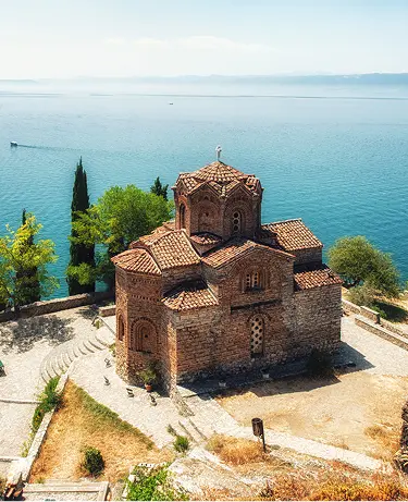 The image captures the iconic Church of St. John at Kaneo, a historical Macedonian Orthodox church in Ohrid, North Macedonia. 