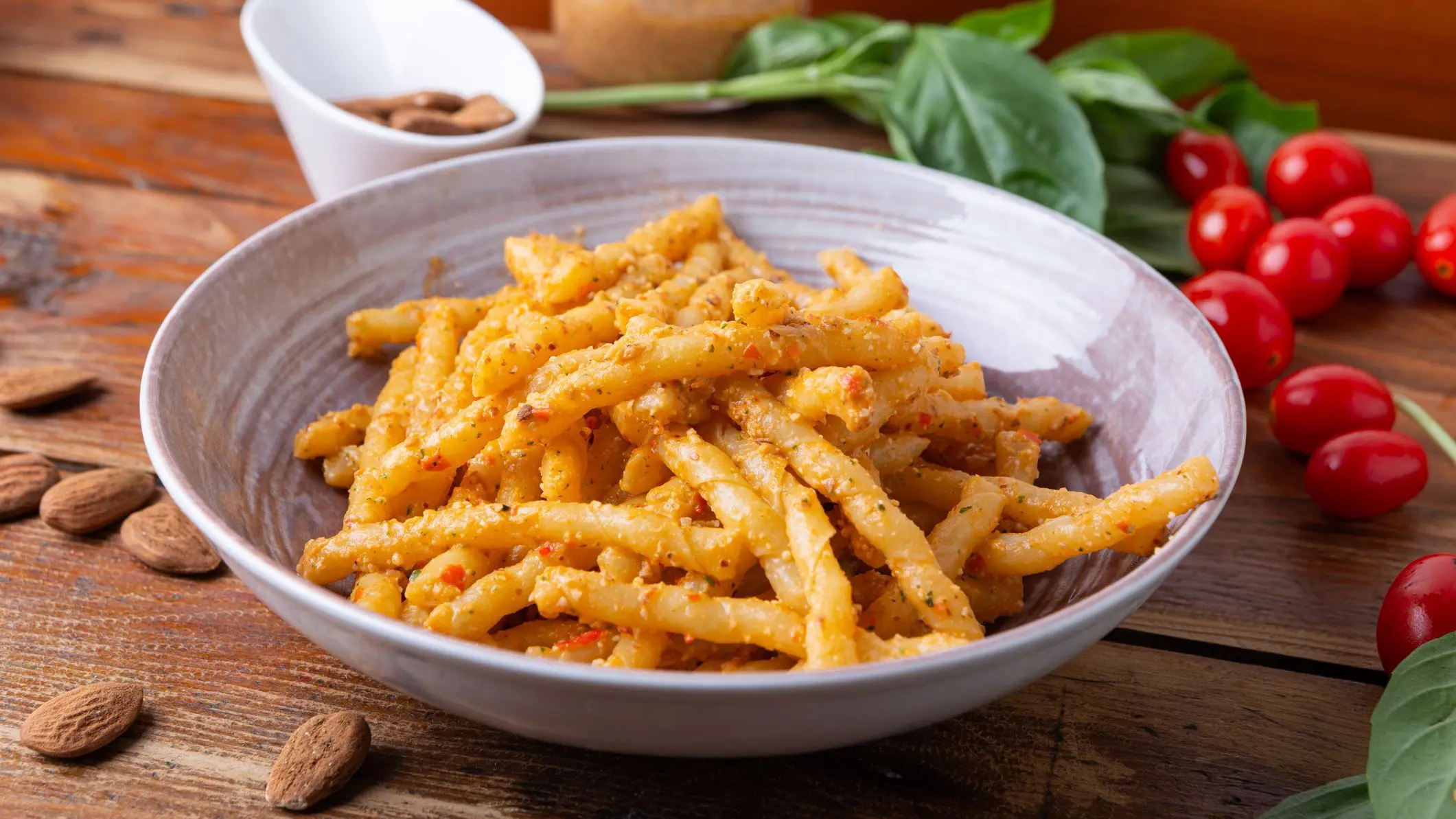 Sicilian pasta with almond and tomato pesto. Typical Italian food from Sicily, pasta with red pesto.