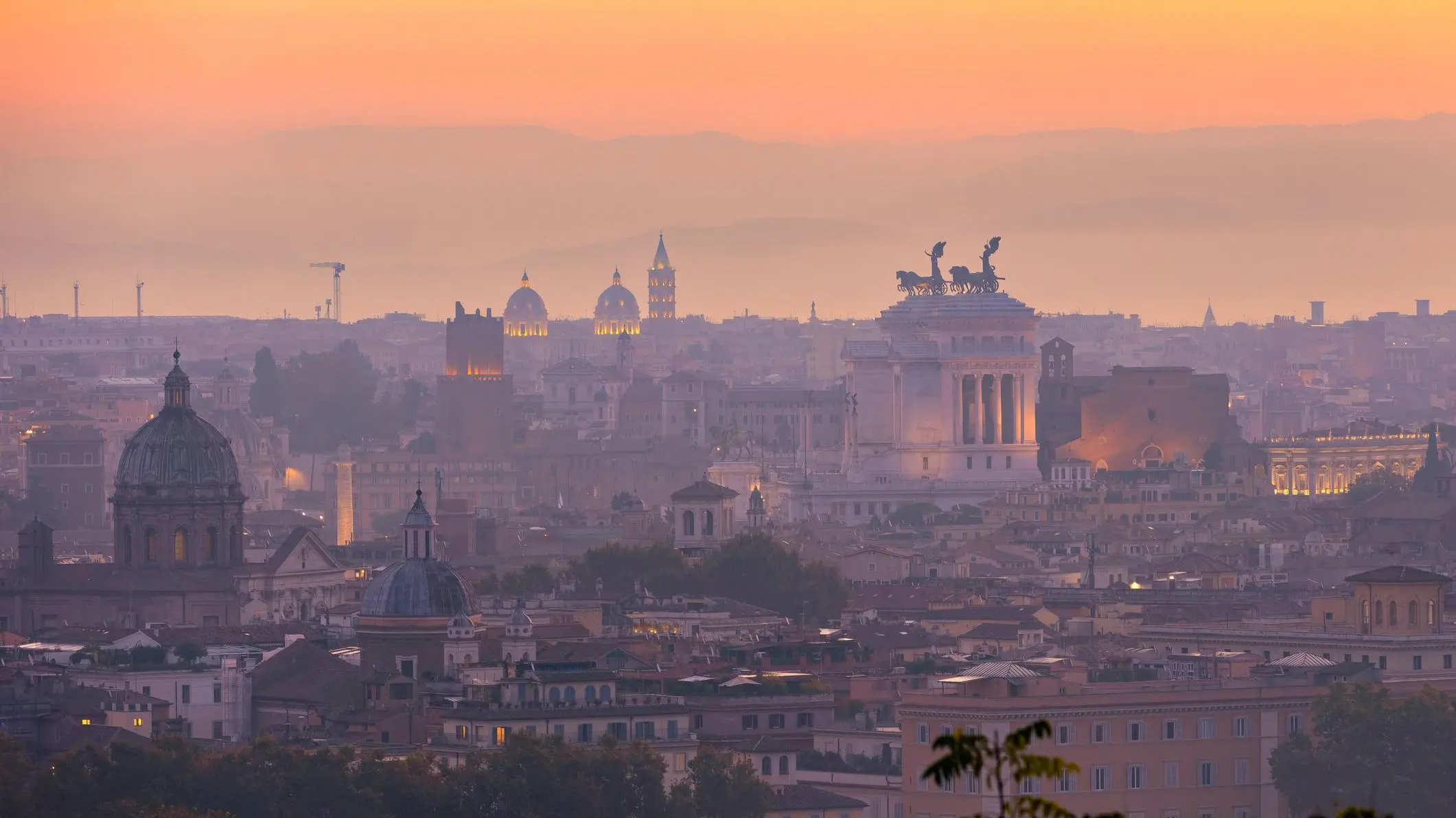 A vibrant sunrise over the city of Rome seen from the Terrazza del Gianicolo and Piazzale Giuseppe Garibaldi.