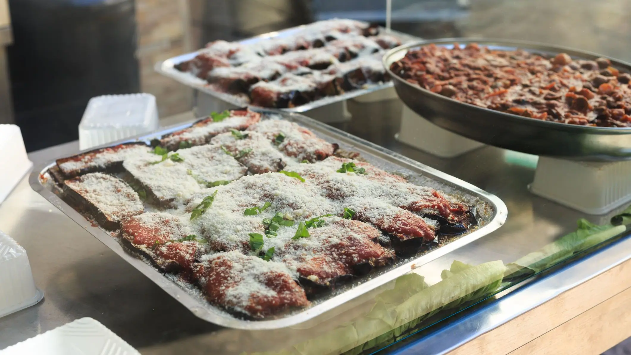 Eggplant parmigiana on a tray displayed at Ballarò market, Palermo, Sicily.