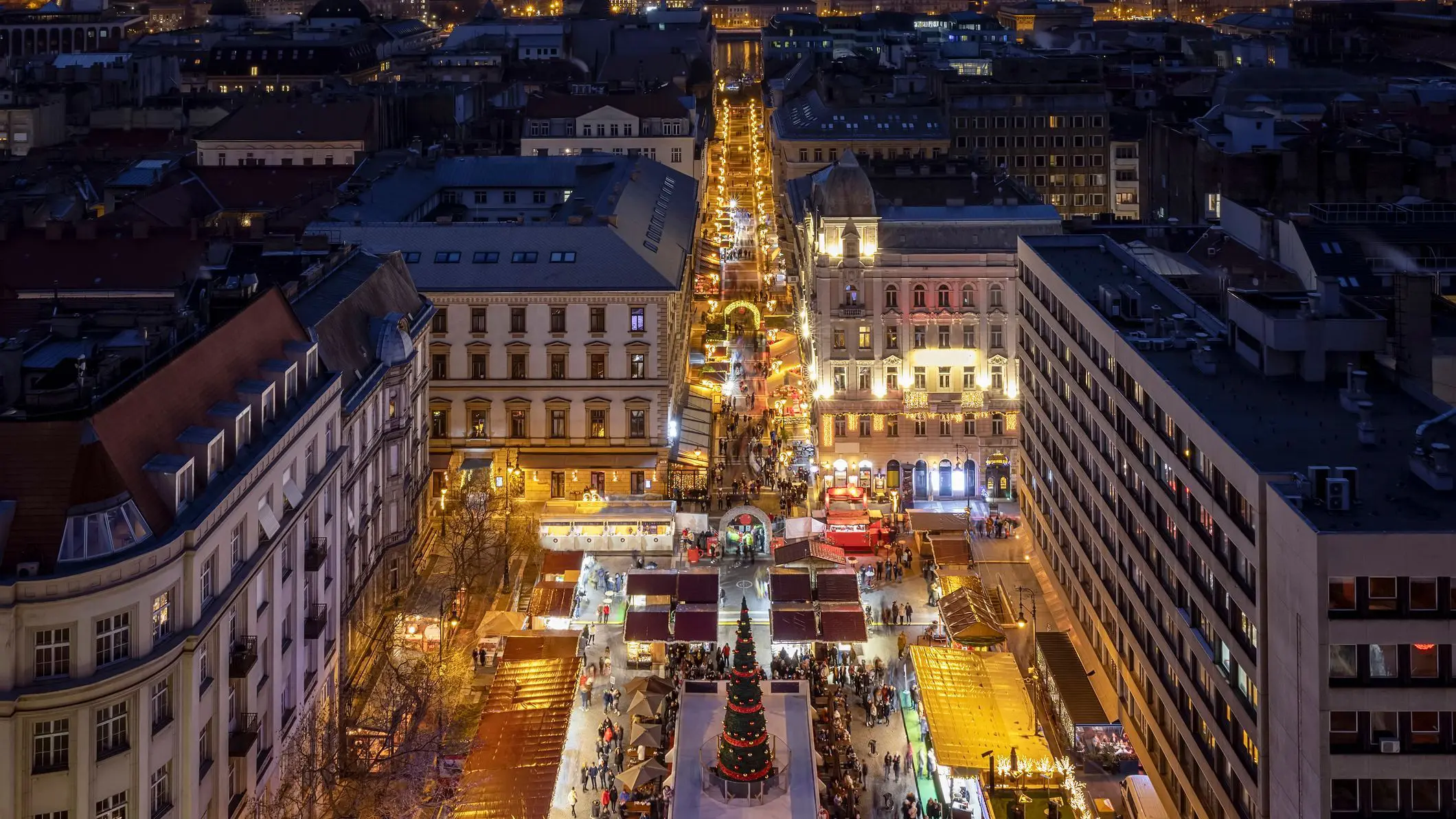 An elevated night view of the famous Christmas market at St. Stephen's Basilica and Square in the old town of Budapest, Hungary.
