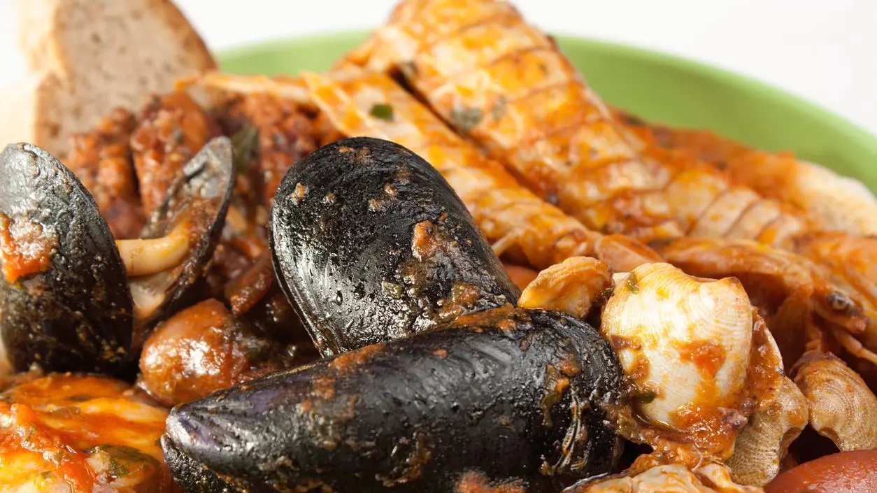 A close-up of seafood in a tomato sauce.