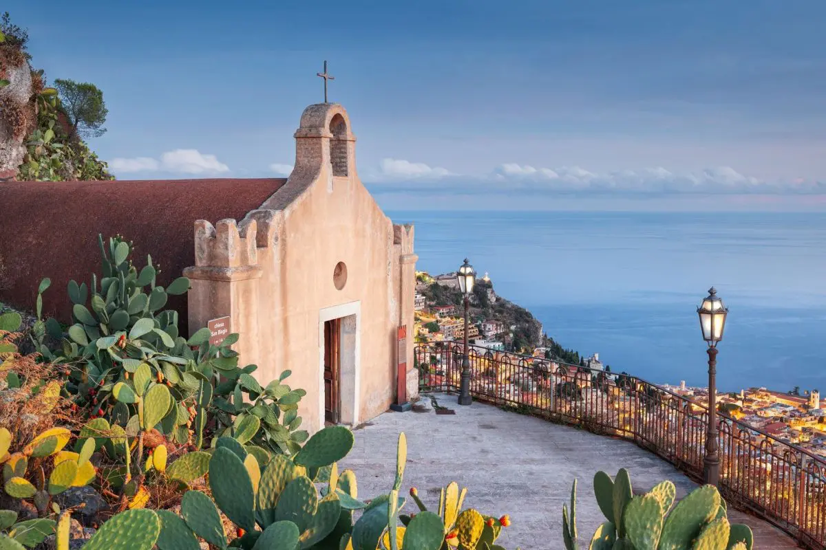 A quaint church overlooking the town of Taormina and the sea beyond.