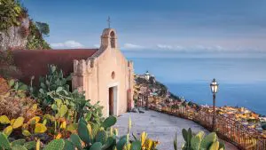 A quaint church overlooking the town of Taormina and the sea beyond.