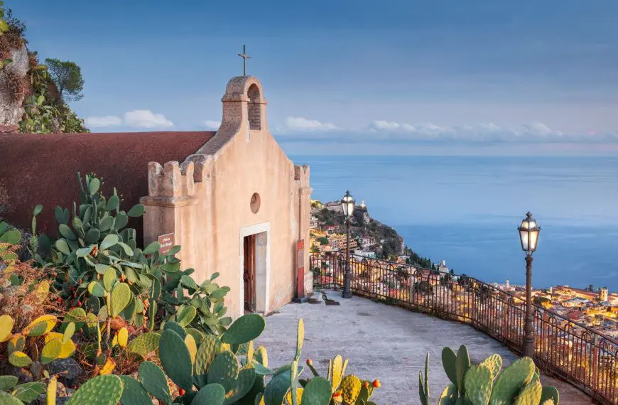 A quaint church overlooking the town of Taormina and the sea beyond.