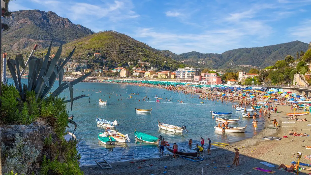 The beach and promenade in Levanto, full of people in the summertime.