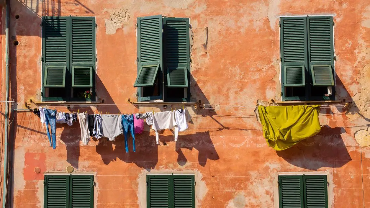 Laundry hangs against colorful, old buildings in Vernazza, one of the five villages that make up Italy's Cinque Terre on the rugged Ligurian coast.