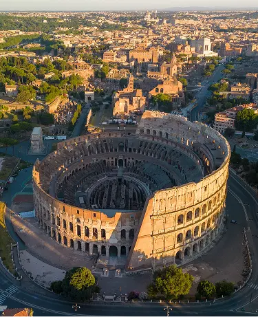 An aerial view of the historic Colosseum and surrounding buildings in Rome, Italy