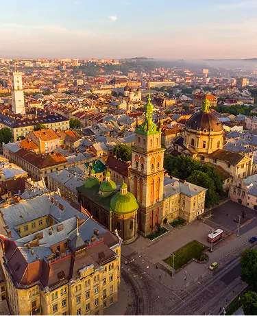 Flying over Lviv City, Ukraine. Town Hall, the tower, Dominican church. Panorama of the ancient city.