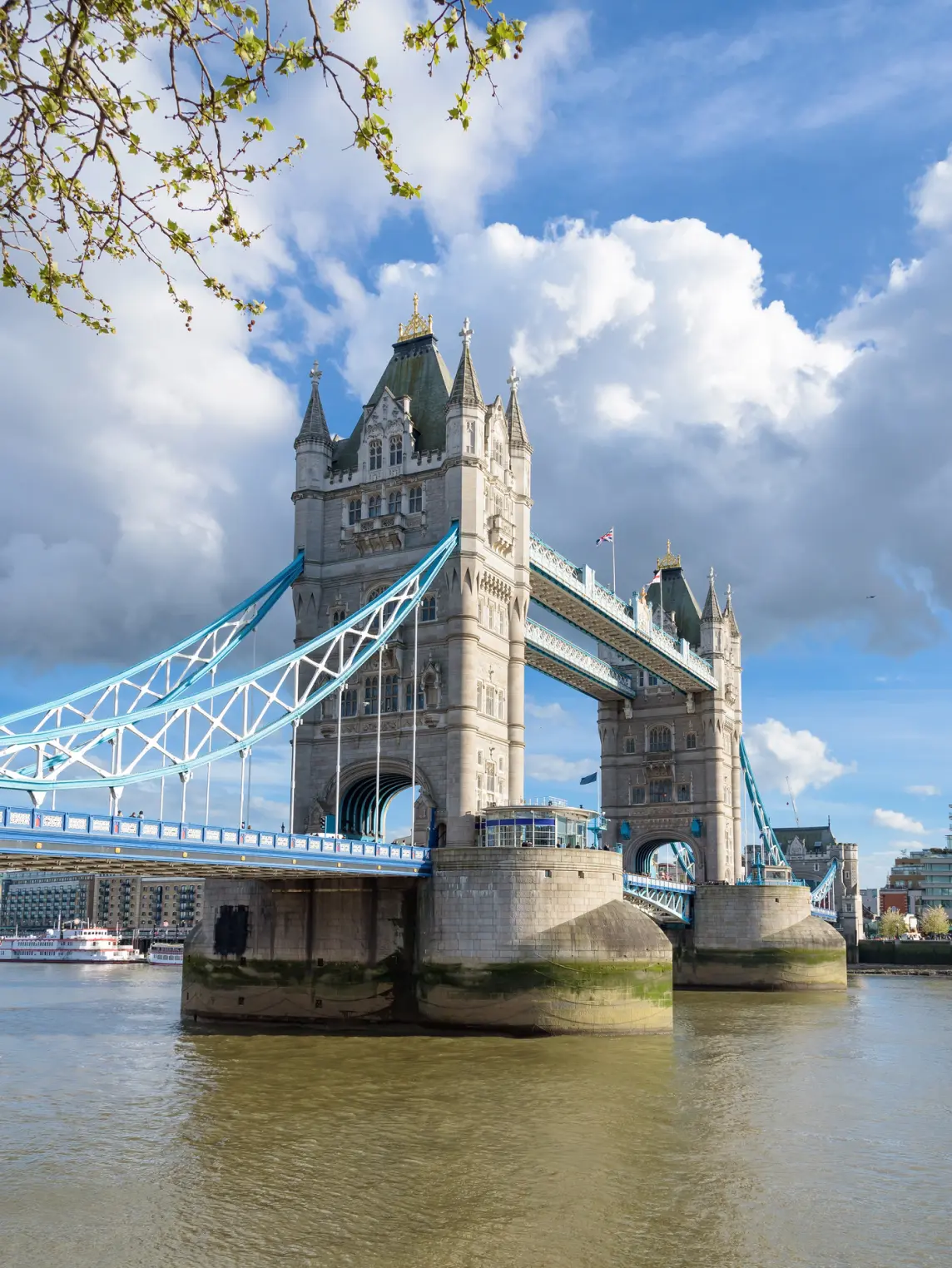 ower Bridge over the River Thames, featuring twin stone towers with blue suspension spans and ornate Victorian Gothic architecture