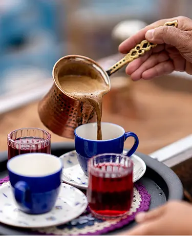 Brewing Turkish coffee on hot sand. The traditional method of making coffee in Turkey and the Middle East
